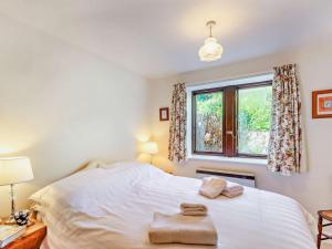 a bedroom with a white bed and a window at 2 Bed in Skipton oc-92898 in Airton