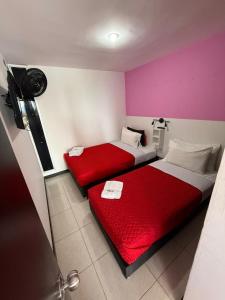 two beds in a room with red and white at Apartahotel Paraíso Cafetero Guaduales del café 401B in Montenegro +14 photos