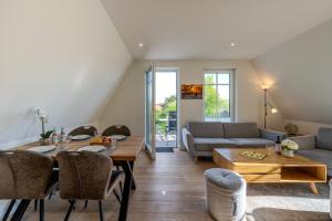 a living room with a table and a couch at Strandhaus Zingst Apartment 16 in Zingst