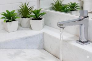 a bathroom sink with water running from a faucet at Casa da Ópera in Diamantina