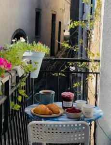 a table with bread and croissants on a balcony at La Vannière in Le Poujol-sur-Orb