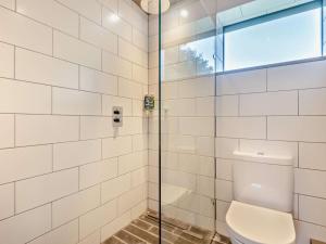 a bathroom with a toilet and a glass shower at 2 Bed in Lymington oc-95021 in Brockenhurst
