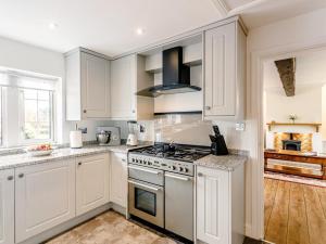 a kitchen with white cabinets and a stove top oven at 1 Bed in Sheffield oc-48259 in Thurlstone