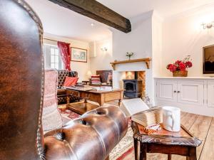 a living room with a leather couch and a fireplace at 1 Bed in Sheffield oc-48259 in Thurlstone +8 photos