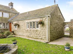 an old stone house with flowers in a yard at 1 Bed in Sheffield oc-48259 in Thurlstone