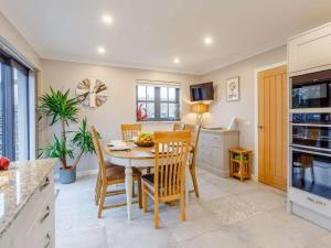 a kitchen and dining room with a table and chairs at 2 Bed in Lairg oc-86104 in Durness