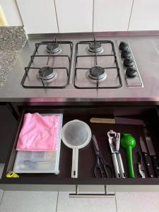 a kitchen drawer with a stove and some kitchen utensils at Apartahotel Paraíso Cafetero Guaduales del café 401B in Montenegro