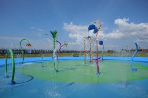 a pool withweredweredwered trees in the water at Fully accessible bungalow by the Beach in Port Talbot