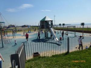 a group of people playing at a playground at Fully accessible bungalow by the Beach in Port Talbot +38 photos