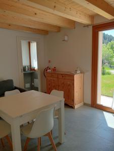 a kitchen and dining room with a table and chairs at Casa ecologica Ai Ronchi in Gallio