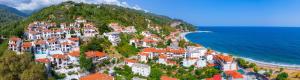 a village on a hill next to the ocean at Irida maria Family studios in Agios Ioannis Pelio