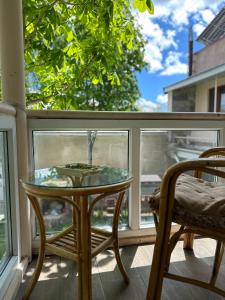 a glass table on a screened in porch with a chair at TAGANI Guest Rooms in Martuni
