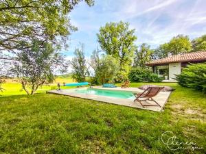 a backyard with a swimming pool and a house at Green Oak Windows & Wood in Albi