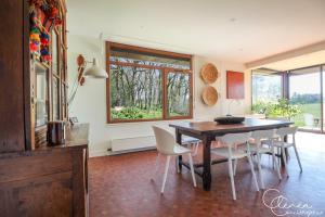 a dining room with a table and some chairs at Green Oak Windows & Wood in Albi