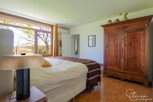 a bedroom with a large bed and a window at Green Oak Windows & Wood in Albi +31 photos