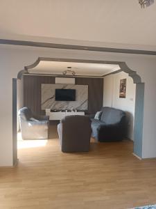 a living room with a couch and a tv at Apartments Stefan Trpejca in Ohrid