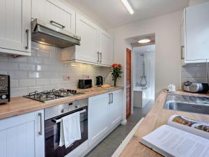 a kitchen with white cabinets and a stove top oven at 2 Bed in Freshwater oc-91606 in Freshwater