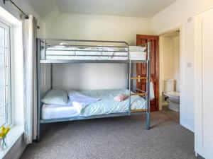 two bunk beds in a room with a toilet at 2 Bed in Freshwater oc-91606 in Freshwater