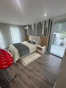 a bedroom with a bed and a large window at Apartamento B T4 Pombal in Pombal +36 photos