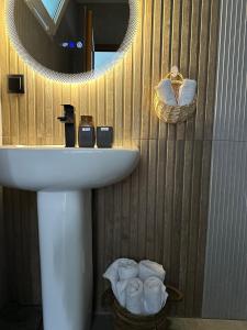 a bathroom with a sink and a mirror and towels at TAGANI Guest Rooms in Martuni +16 photos