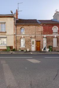 an empty street in front of a brick building at Le 120 Amiens in Amiens