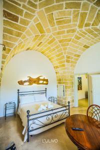 a bedroom with a bed and a stone ceiling at B&b Casina Il Mandorlo in Nardò +89 photos