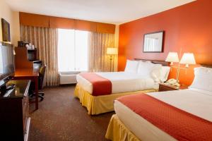 a hotel room with two beds and a television at Holiday Inn O'Hare Area by IHG in Rosemont +68 photos