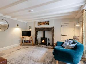a living room with a blue chair and a fireplace at 2 Bed in Hope Valley oc-88979 in Sheffield