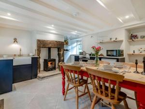 a kitchen and dining room with a table and a fireplace at 2 Bed in Hope Valley oc-88979 in Sheffield