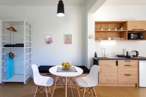 a kitchen with a table and chairs in a room at Coastline Studio Apartment Ligia Bay in Lygia
