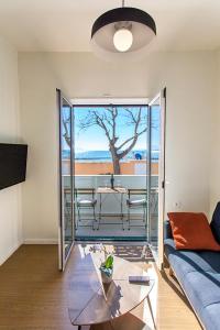 a living room with a couch and a table at Coastline Studio Apartment Ligia Bay in Lygia