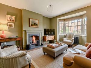 a living room with a fireplace and a couch and chairs at 2 Bed in Helmsley oc-92946 in Helmsley