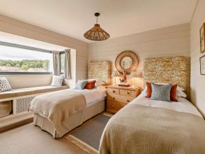 a bedroom with two beds and a window at 2 Bed in Helmsley oc-92946 in Helmsley