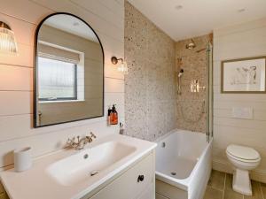 a bathroom with a sink and a tub and a toilet at 2 Bed in Helmsley oc-92946 in Helmsley +35 photos