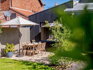 a patio with a table and an umbrella at 2 Bed in Helmsley oc-92946 in Helmsley