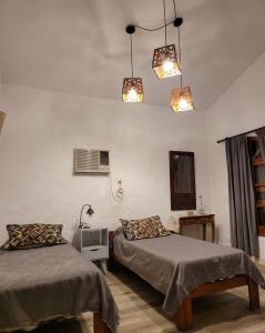 a room with two beds and two lights at Monoambiente KALKI in Roldán