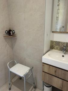 a bathroom with a sink and a chair in it at Le jardin de la mer in Wierre-Effroy +58 photos