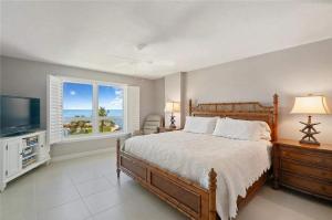 a bedroom with a large bed and a television at Islamorada Oceanfront Luxury Living in Islamorada