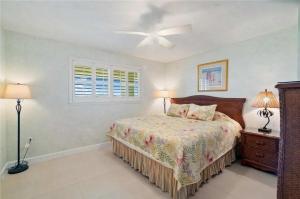 a bedroom with a bed and two lamps and a window at Islamorada Oceanfront Luxury Living in Islamorada