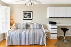 a bedroom with a bed with a striped blanket at Islamorada Oceanfront Luxury Living in Islamorada