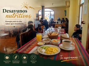 a table with breakfast food on it in a restaurant at Urku Ñan Quilotoa in Sigchos