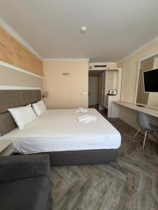a hotel room with a bed and a couch at Sun Boutique Pomorie in Pomorie +30 photos