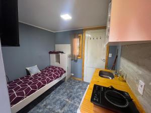 a small room with a bed and a desk at Sierras de Canela Tiny in Tandil