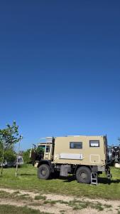 a military truck parked in a field of grass at Marina Park Camping in Vama Veche
