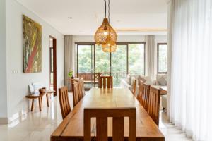 a dining room and living room with a table and chairs at Hikari Hill View Villa 7 Bedrooms With a Private Swimming Pool and a Billiard Table in Bandung