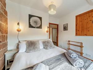 a bedroom with a bed with pillows on it at 2 Bed in Kelsall oc-94445 in Kelsall