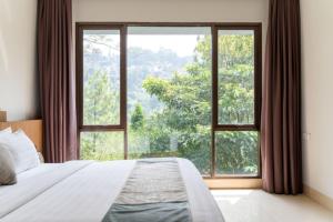a bedroom with a bed and a large window at Hikari Hill View Villa 7 Bedrooms With a Private Swimming Pool and a Billiard Table in Bandung +45 photos