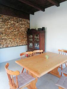 a wooden table and chairs in a room at Apartmaji Karbic in Postojna
