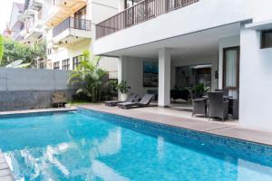a swimming pool in front of a building at Hikari Hill View Villa 7 Bedrooms With a Private Swimming Pool and a Billiard Table in Bandung