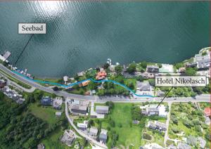 arial view of a city with a road and the water at Hotel Nikolasch mit eigenem Seebad - Adults Preferred in Millstatt